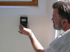 Inspecting the walls for moisture content